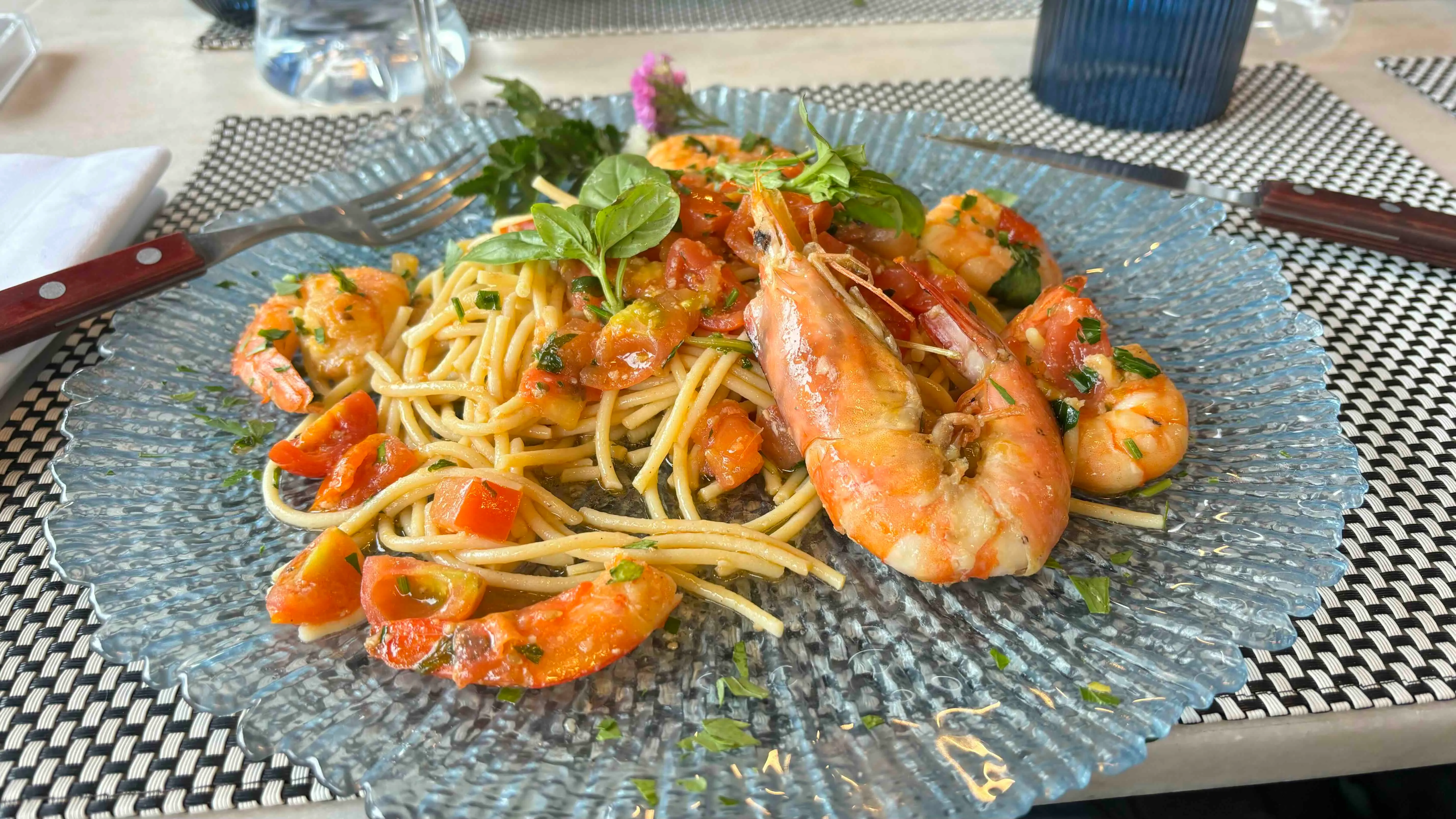 Gluten-free spaghetti with shrimp, cherry tomatoes, and peppery rocket