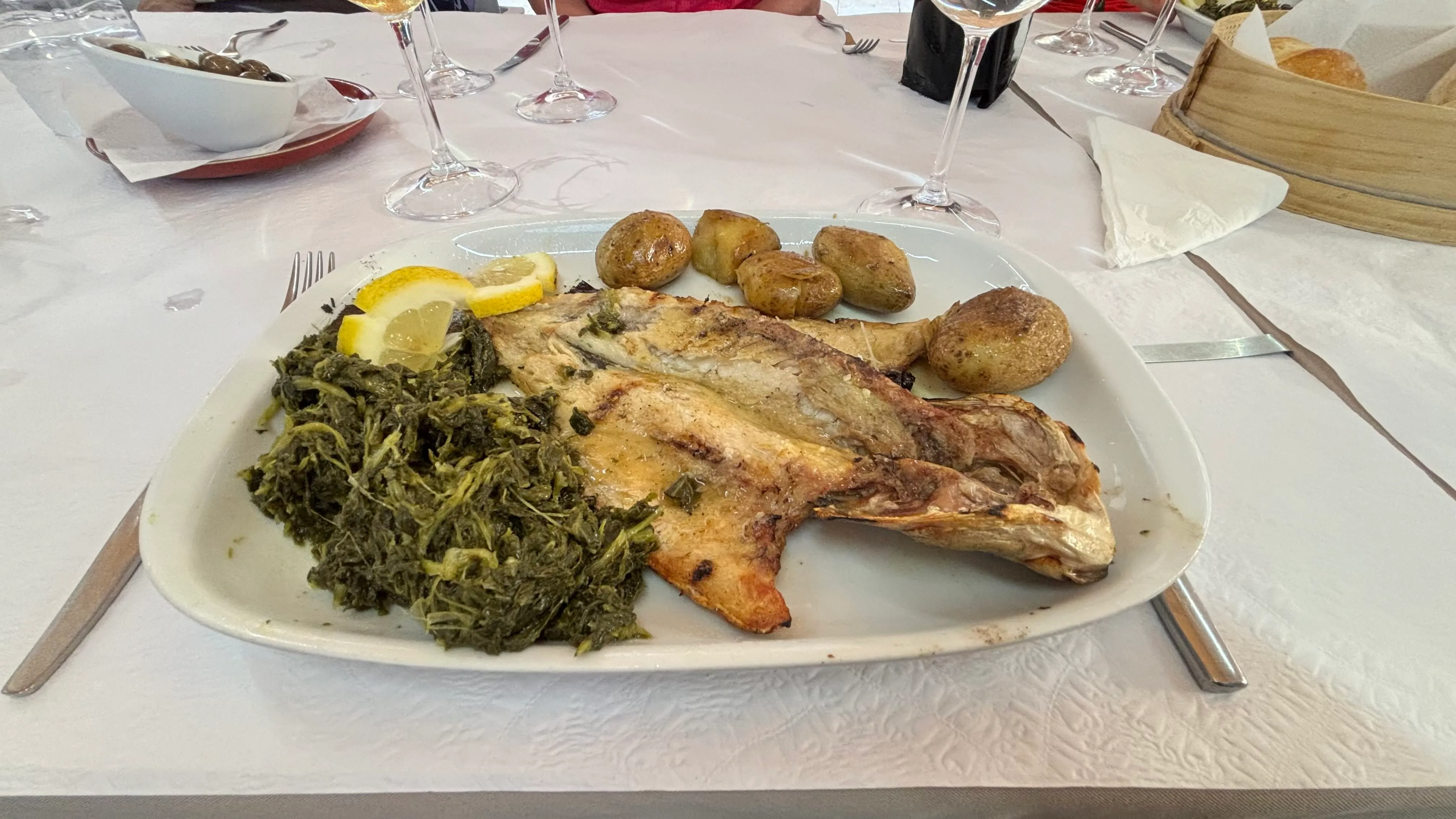 Grilled sea bass served with spinach and potatoes